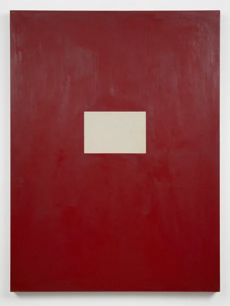 A large red abstract painting on unframed linen with a pale rectangular aperture at its centre