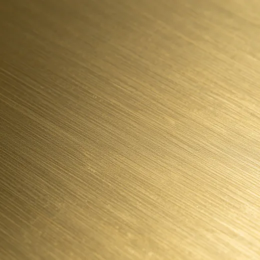 Close-up of unlacquered satin brass with a fine brushed grain.