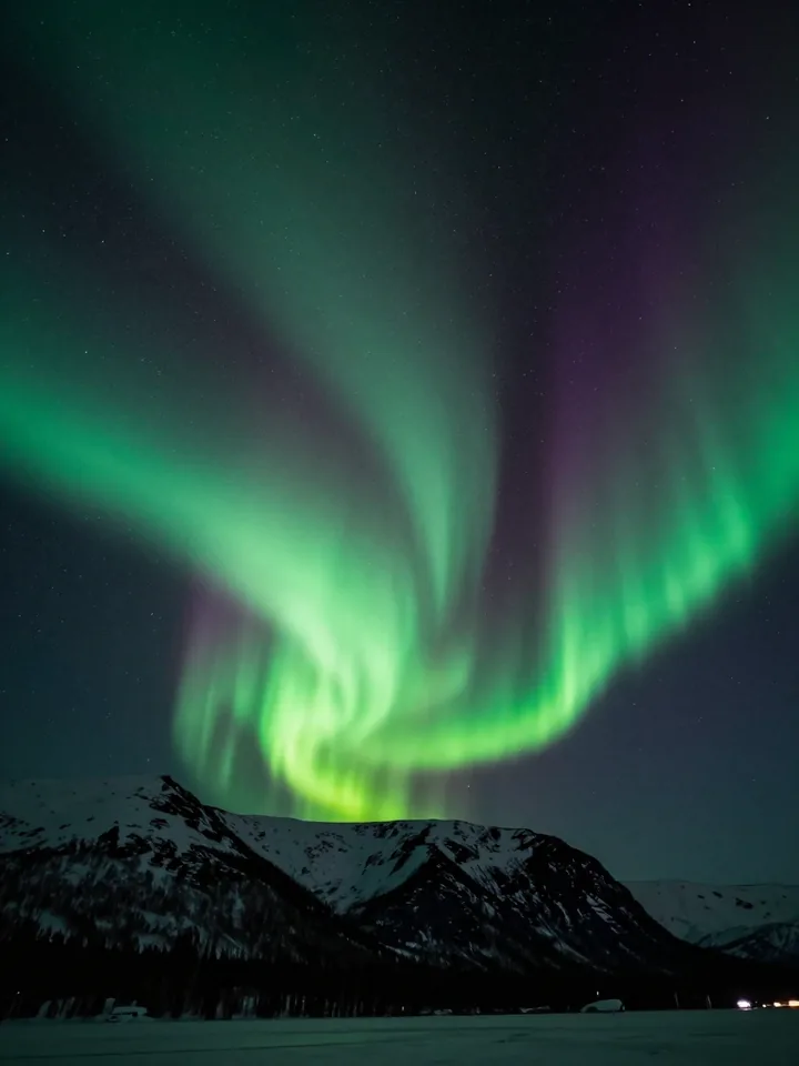 Green aurora ribbons rippling over a dark starfield